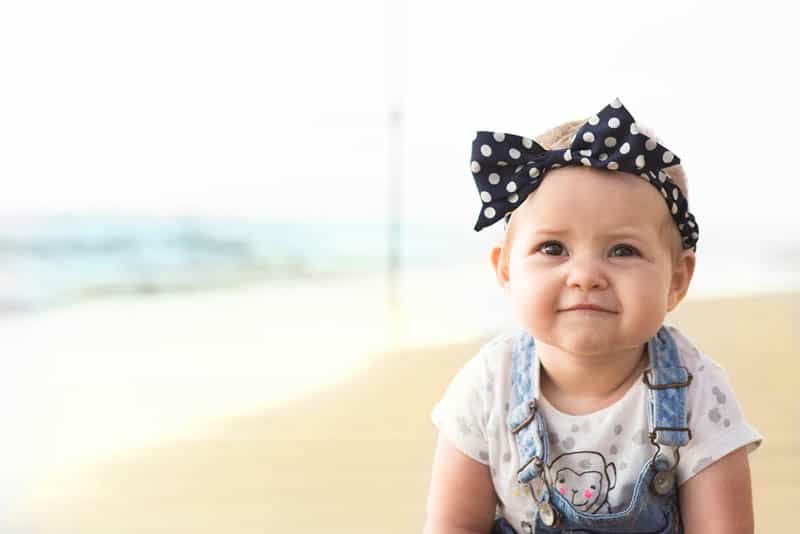 adorable baby girl wearing headband outdoor