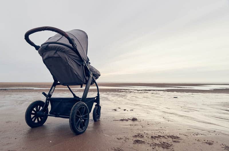 baby strollers in the sand on the beach