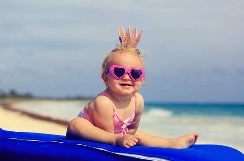 cute little baby princess on summer tropical beach