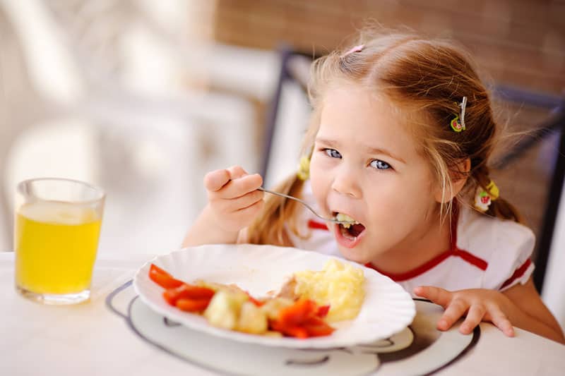cute little girl eating a breakfast