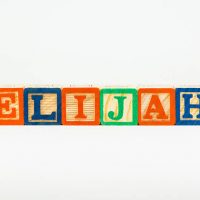 the name Elijah spelled out with colorful wooden blocks