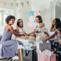 women celebrating a baby shower with pregnant woman