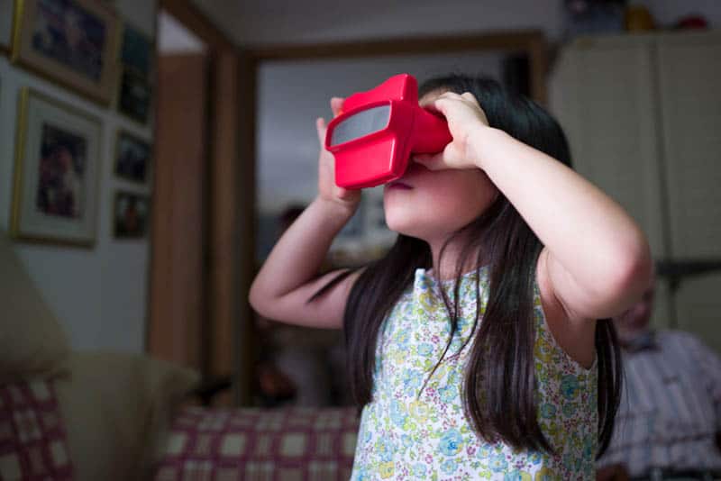 Girl looking through stereoscopic Viewfinder toy