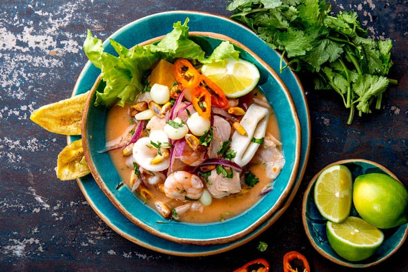 Peruvian seafood and fish sebiche with maize on the table