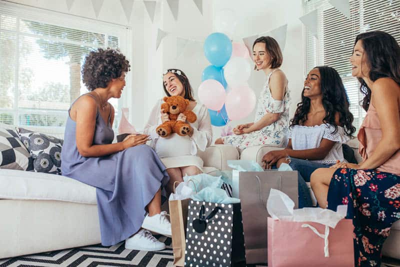 Pregnant woman celebrating baby shower party with friends