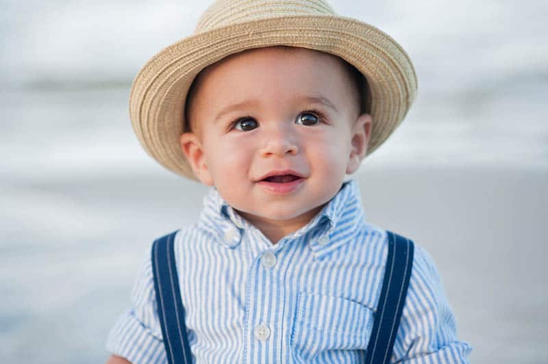 cute little boy wearing a shirt and hat outdoor