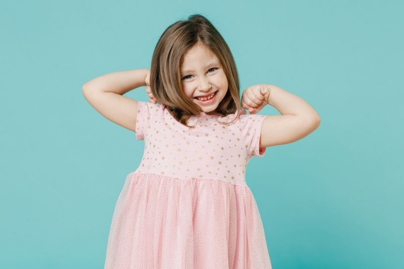 Little girl in a pink dress smiling