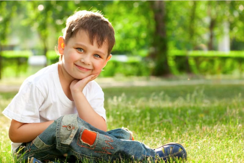 little boy sitting in the park