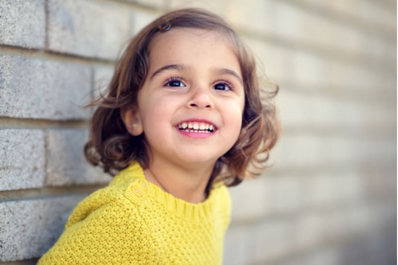 little girl wearing yellow sweater