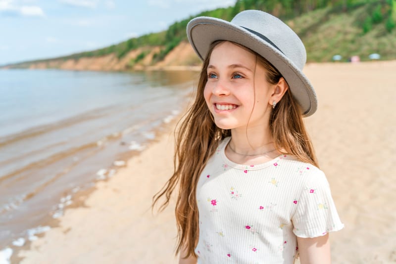 smiling little girl wearing hat