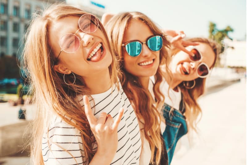 three young beautiful smiling hipster girls