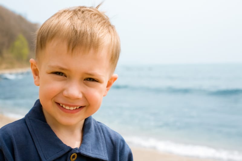 Smiling boy on a background of the sea