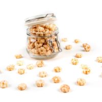 baby puffs in a glass jar in front of a white background