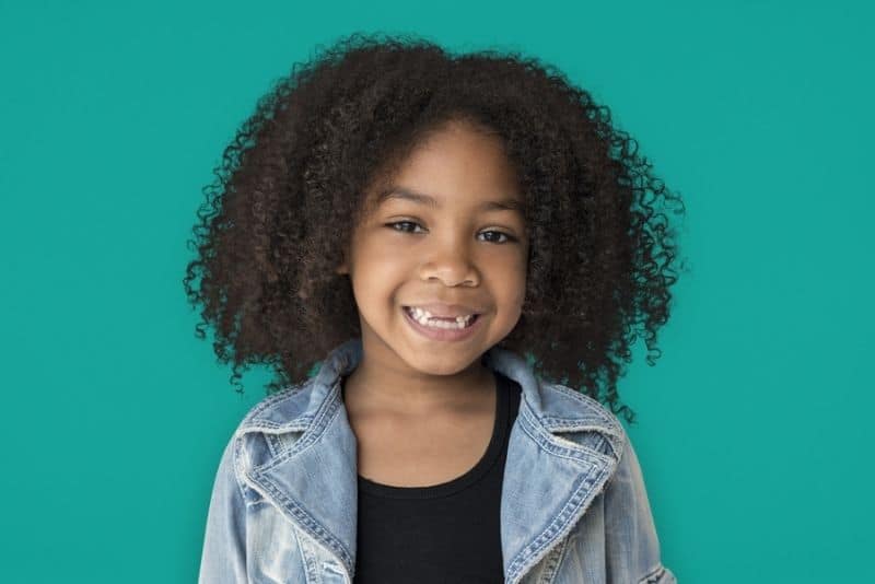 Cute little girl with curly hair smiling