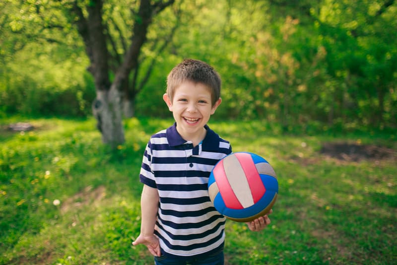 cute little boy holding ball