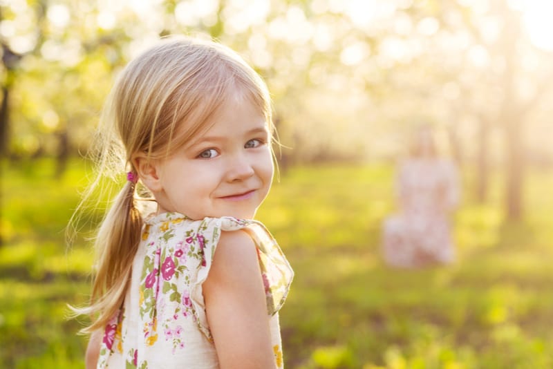 little girl in blossoming garden