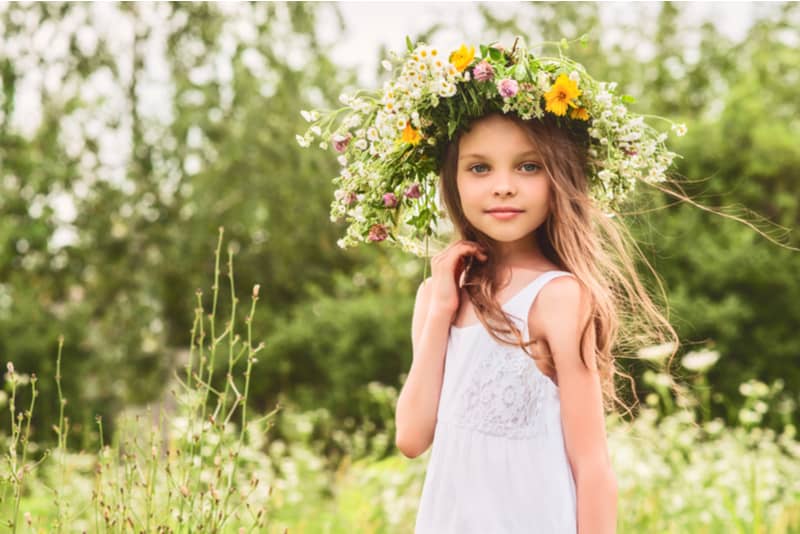 little girl with flower wreath on the head 