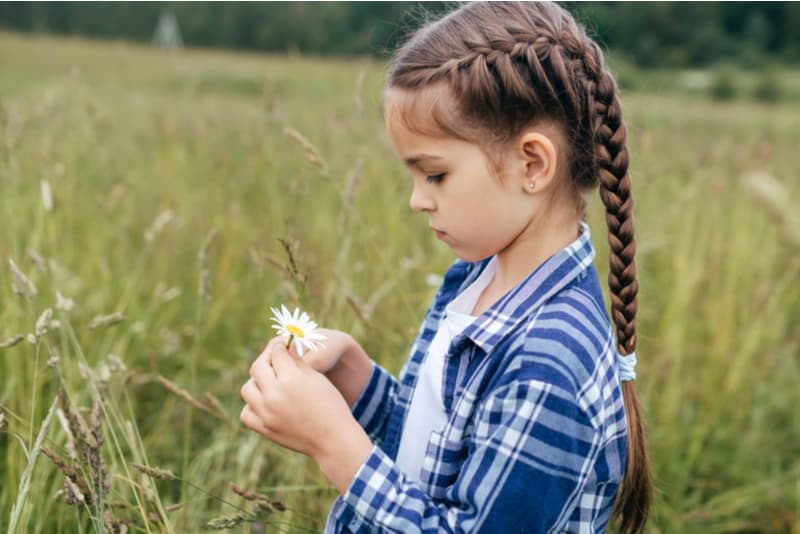 little girl with long hair wearing checkered shirt
