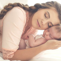 young mother cuddling with newborn baby