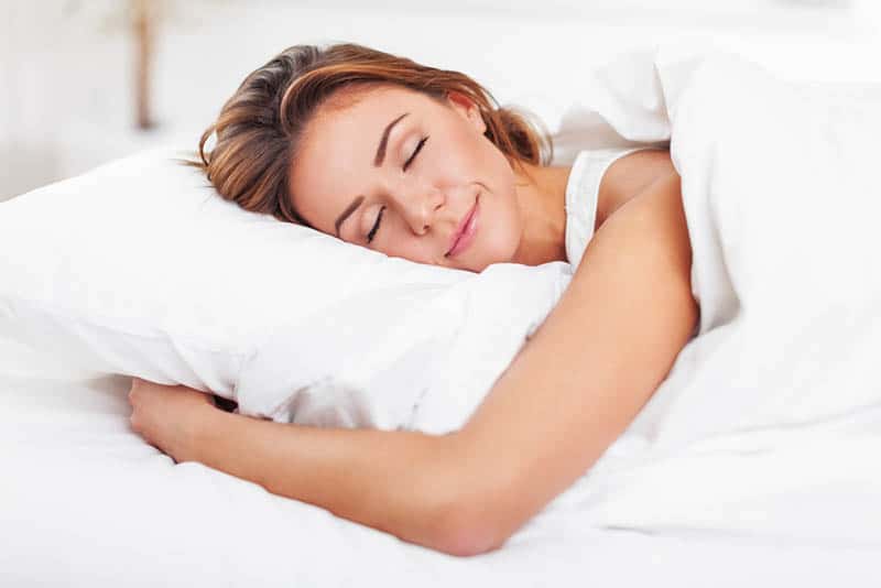 beautiful happy woman sleeping in bed