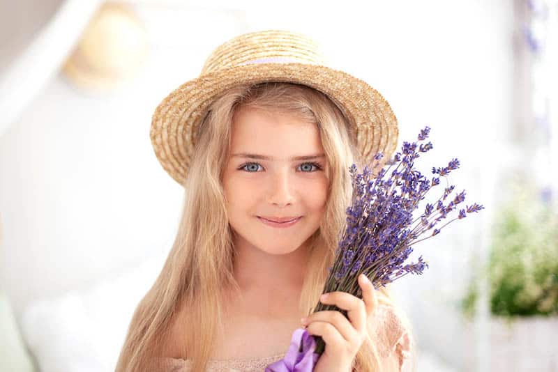 beautiful little girl holding a lavender