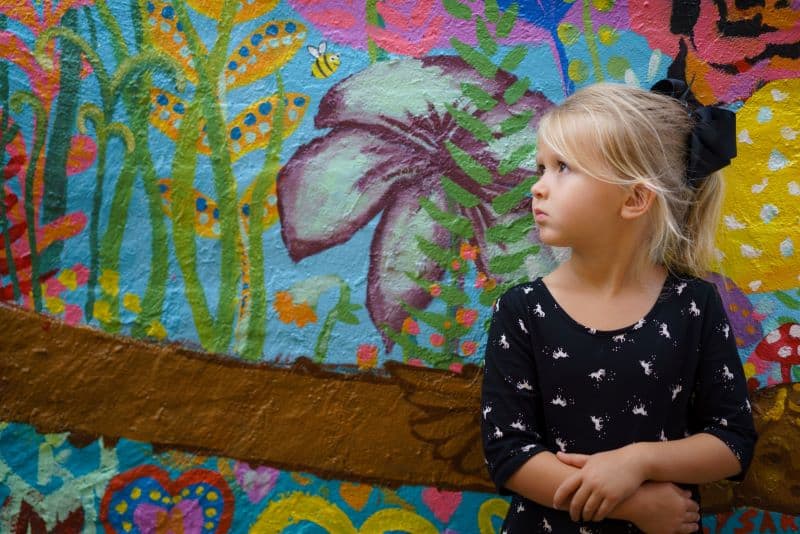 girl in front of a graffitti wall