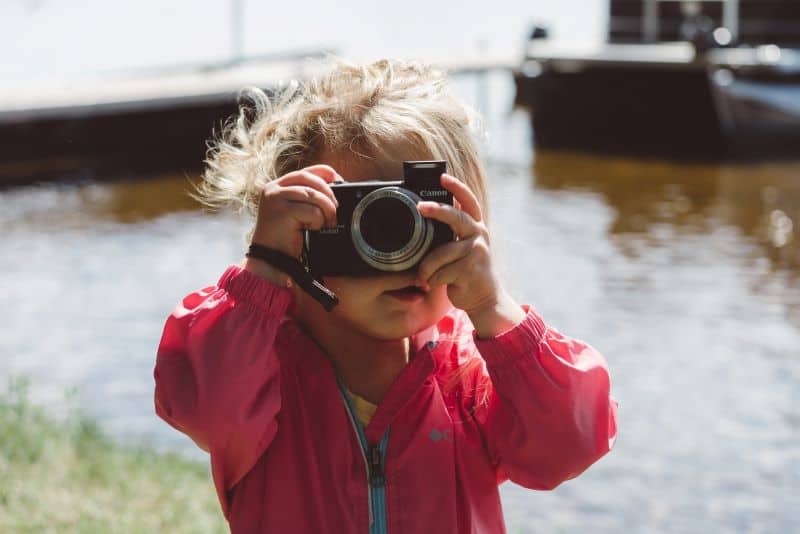 little girl holding a camera