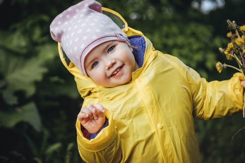 girl wearing a yellow raincoat